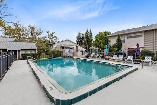 pool with fence and a patio