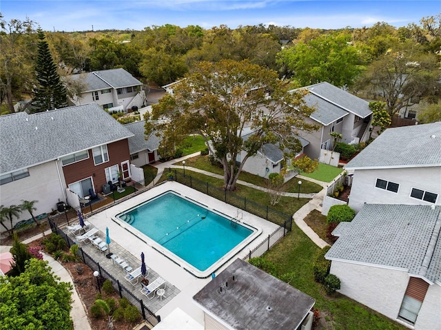 community pool featuring a fenced backyard and a residential view