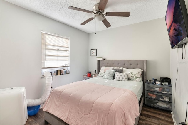 bedroom with a ceiling fan, a textured ceiling, and wood finished floors