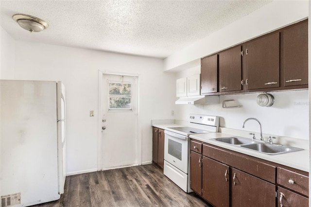 kitchen with white appliances, a sink, visible vents, light countertops, and dark wood-style floors