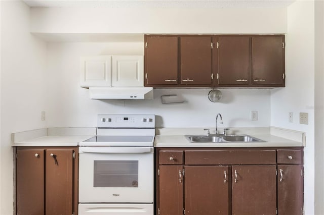 kitchen featuring light countertops, a sink, under cabinet range hood, and white range with electric cooktop