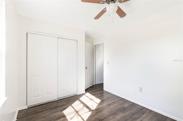 unfurnished bedroom with ceiling fan, a closet, wood finished floors, and baseboards