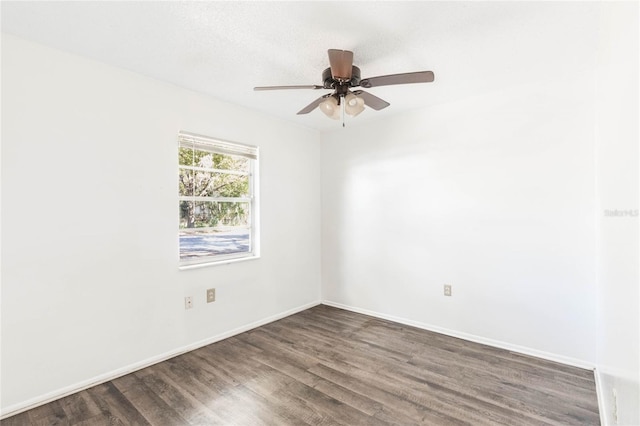 empty room with ceiling fan, baseboards, and wood finished floors