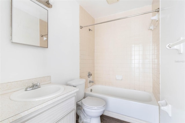 bathroom featuring toilet, washtub / shower combination, and vanity