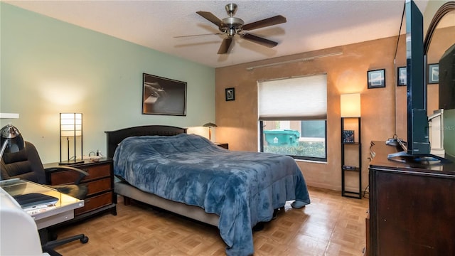 bedroom with a textured ceiling and light floors