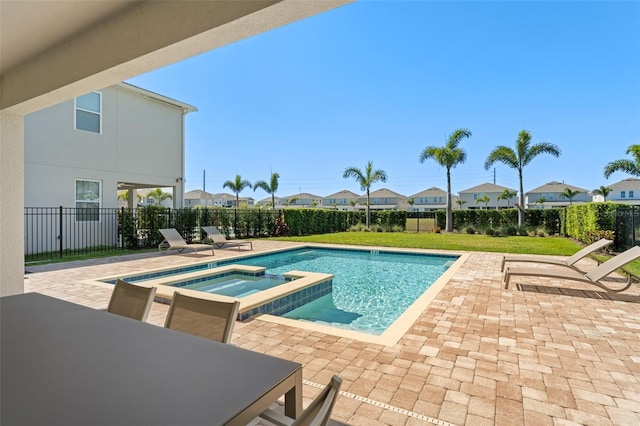 view of swimming pool featuring a patio area, a residential view, a pool with connected hot tub, and fence