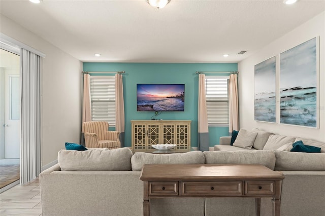 living room featuring recessed lighting and visible vents