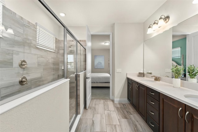 bathroom with double vanity, a stall shower, ensuite bathroom, and a sink