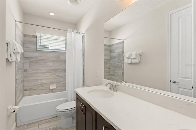 bathroom with vanity, shower / bath combination with curtain, and toilet