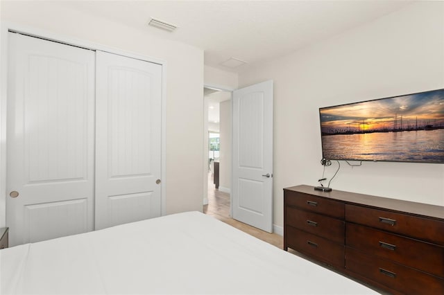 bedroom featuring visible vents and a closet