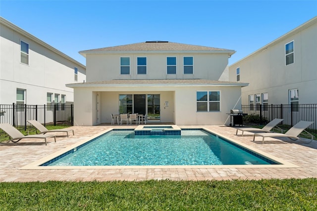 rear view of property featuring stucco siding, a patio, and fence