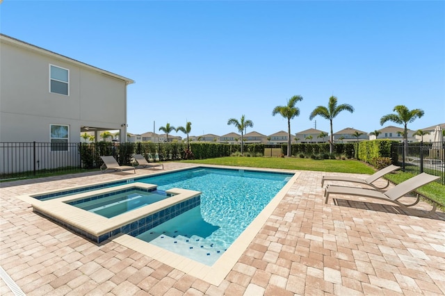 view of pool featuring a patio, fence, a residential view, and a pool with connected hot tub