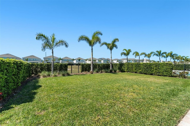 view of yard with a residential view and a fenced backyard