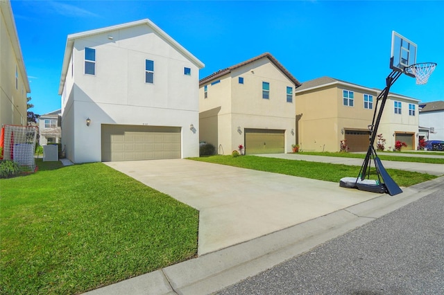 view of front of house with a garage, driveway, a front yard, and stucco siding