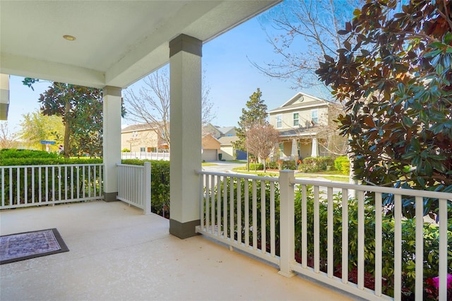 balcony featuring covered porch and a residential view