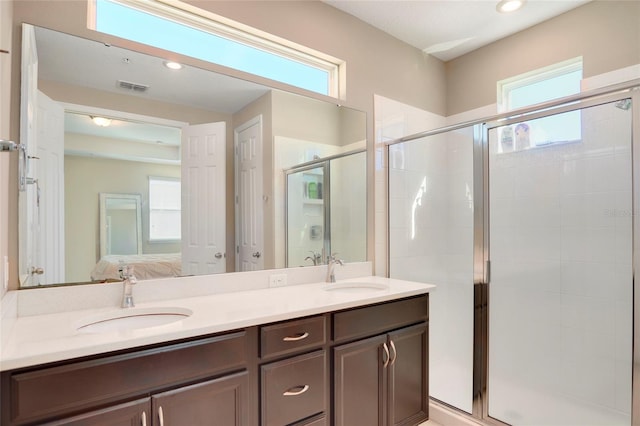 bathroom with a healthy amount of sunlight, ensuite bath, visible vents, and a sink