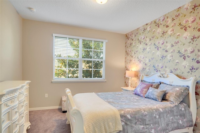 carpeted bedroom featuring baseboards and a textured ceiling