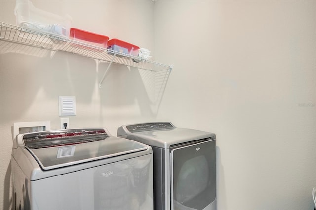 washroom featuring laundry area and separate washer and dryer