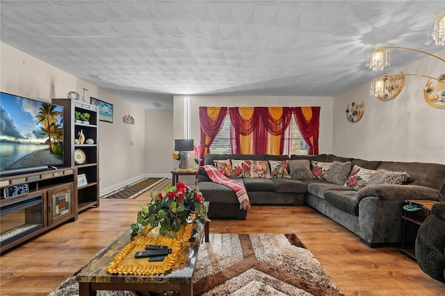 living area with baseboards and wood finished floors