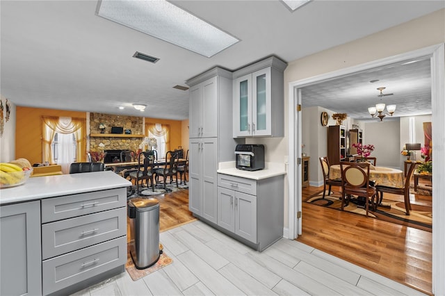 kitchen featuring visible vents, gray cabinets, and light wood finished floors