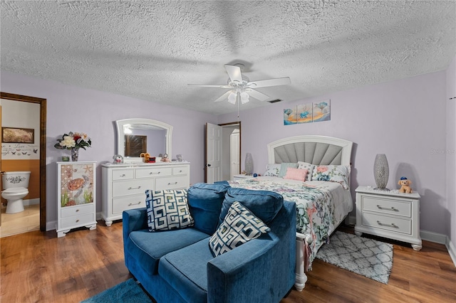 bedroom featuring a ceiling fan, wood finished floors, and a textured ceiling