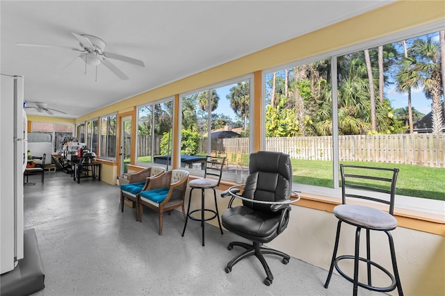 sunroom featuring plenty of natural light and ceiling fan