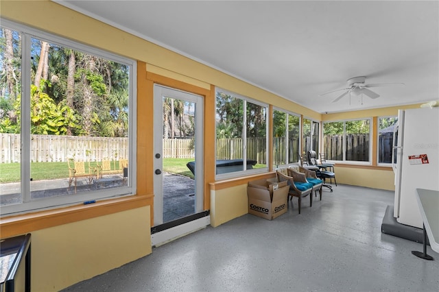 unfurnished sunroom featuring ceiling fan