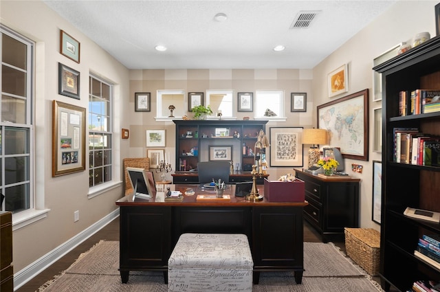 office space with dark wood-style floors, visible vents, recessed lighting, and baseboards