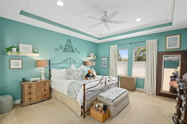 bedroom featuring carpet, a tray ceiling, and ornamental molding