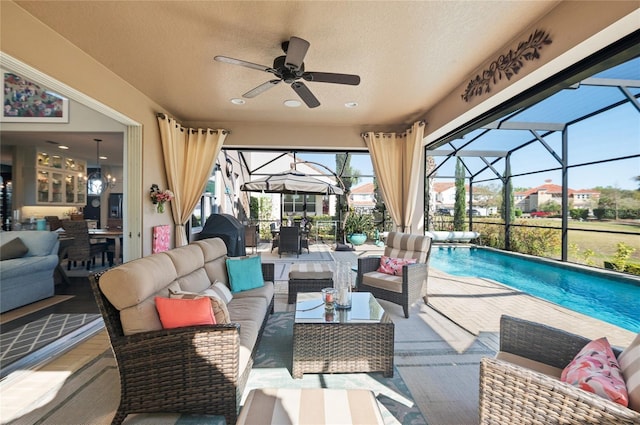 view of patio / terrace featuring outdoor dining space, a ceiling fan, glass enclosure, an outdoor pool, and an outdoor hangout area