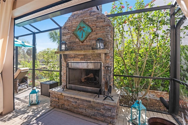 unfurnished sunroom with an outdoor stone fireplace