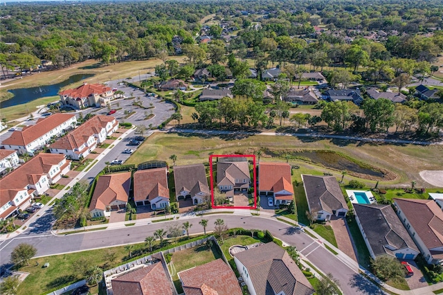 drone / aerial view with a residential view and a water view