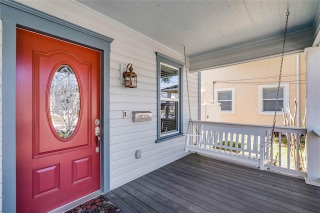 view of exterior entry with a porch