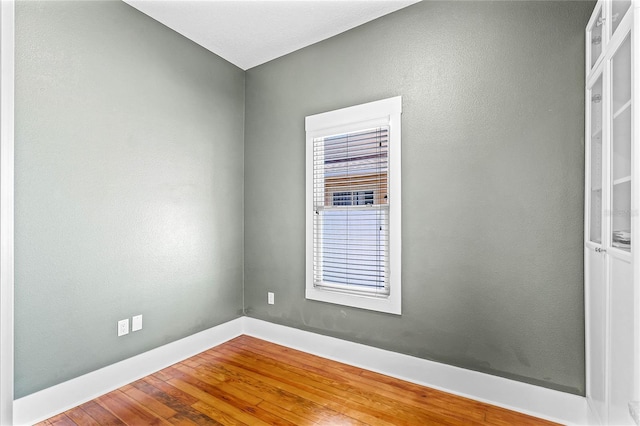 unfurnished room featuring hardwood / wood-style flooring