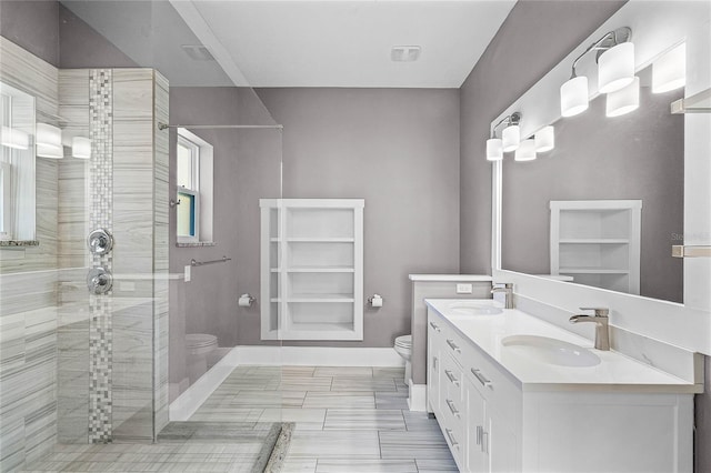 bathroom with a walk in shower, toilet, baseboards, and a sink