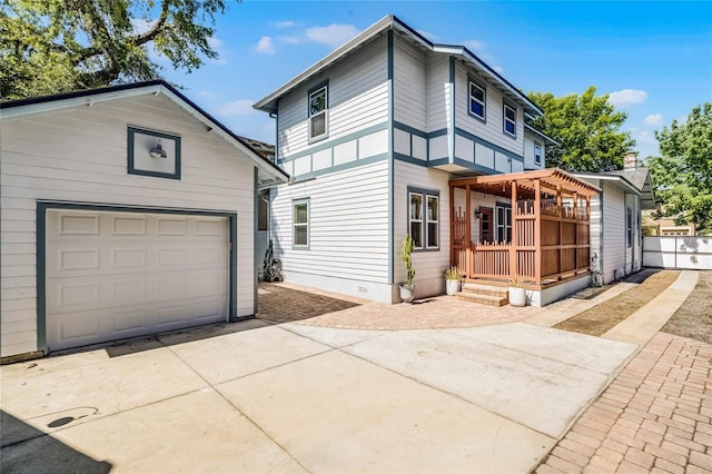 view of front of property with an outbuilding, fence, a pergola, concrete driveway, and crawl space