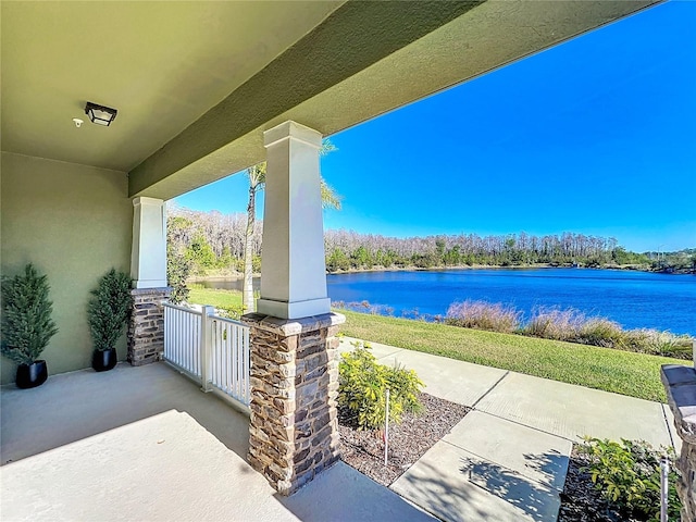 view of patio / terrace featuring covered porch and a water view