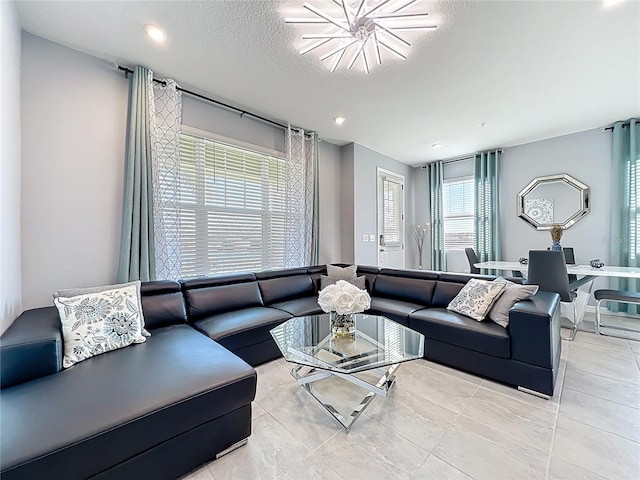 living room featuring light tile patterned floors and a textured ceiling