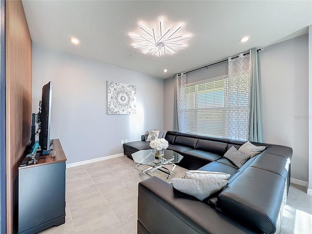 living room featuring recessed lighting, a textured ceiling, and baseboards