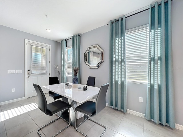 dining area with light tile patterned floors and baseboards