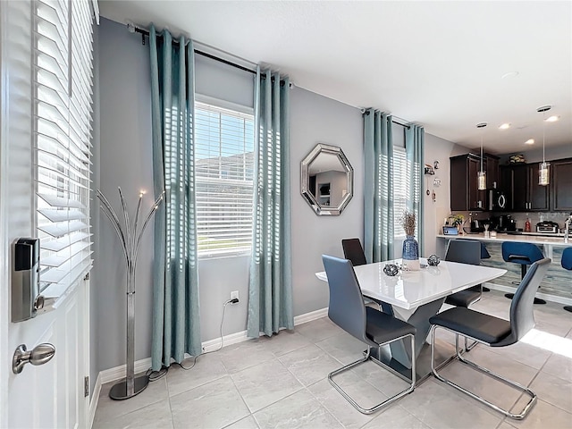 dining room featuring light tile patterned floors and baseboards