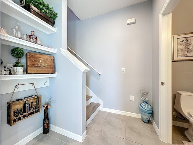 stairway with tile patterned flooring and baseboards