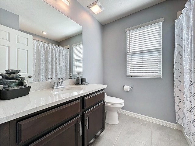 bathroom with visible vents, toilet, vanity, tile patterned flooring, and baseboards