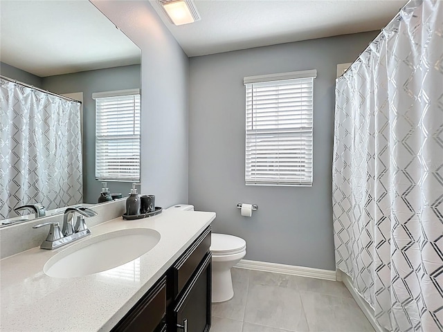 full bath featuring toilet, vanity, a shower with curtain, baseboards, and tile patterned floors