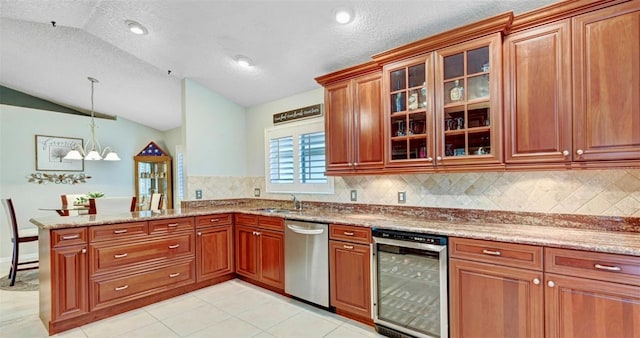 kitchen featuring lofted ceiling, stainless steel dishwasher, a sink, beverage cooler, and a peninsula