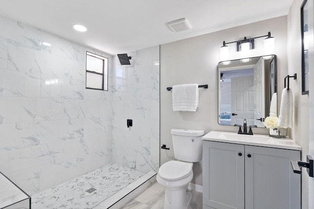 full bathroom with marble finish floor, a marble finish shower, visible vents, toilet, and vanity