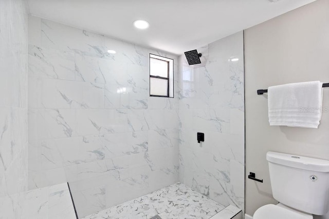 bathroom with toilet, tiled shower, and recessed lighting