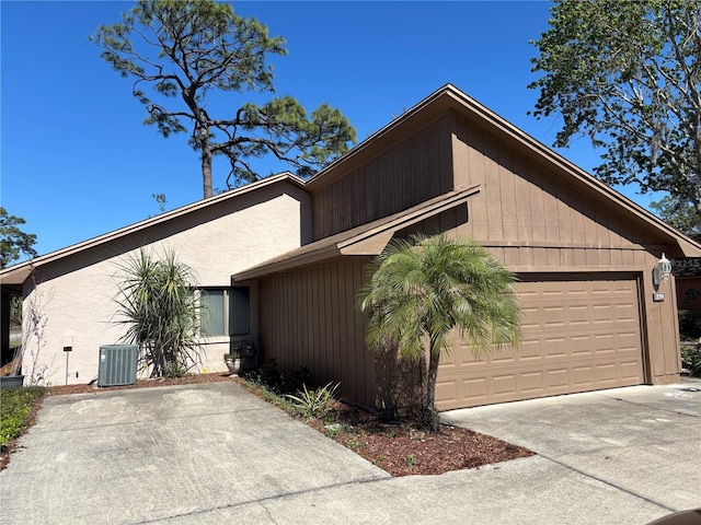 view of front facade featuring a garage, driveway, and central AC unit