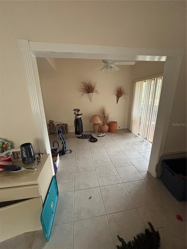 interior space with tile patterned flooring and a ceiling fan