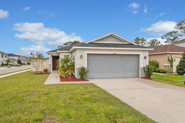 ranch-style home featuring a shingled roof, concrete driveway, stucco siding, an attached garage, and a front yard